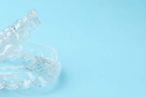 clear aligners on a light blue background
