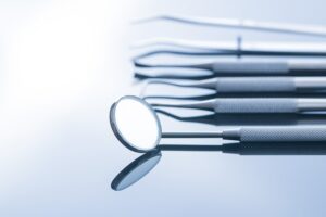 Dental instruments. Dentists tools on mirror background.