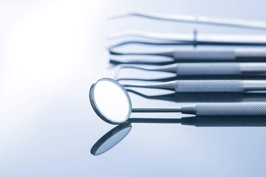 Dental instruments. Dentists tools on mirror background.