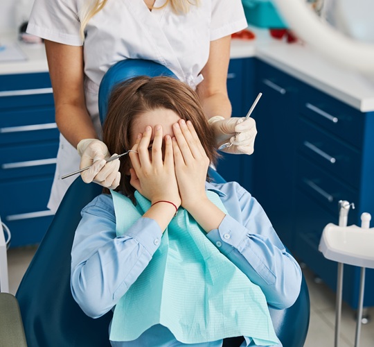 Dental patient displaying signs of anxiety about being at the dentist.