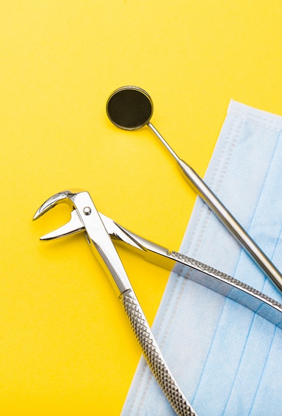 Dental tools arranged on a yellow background